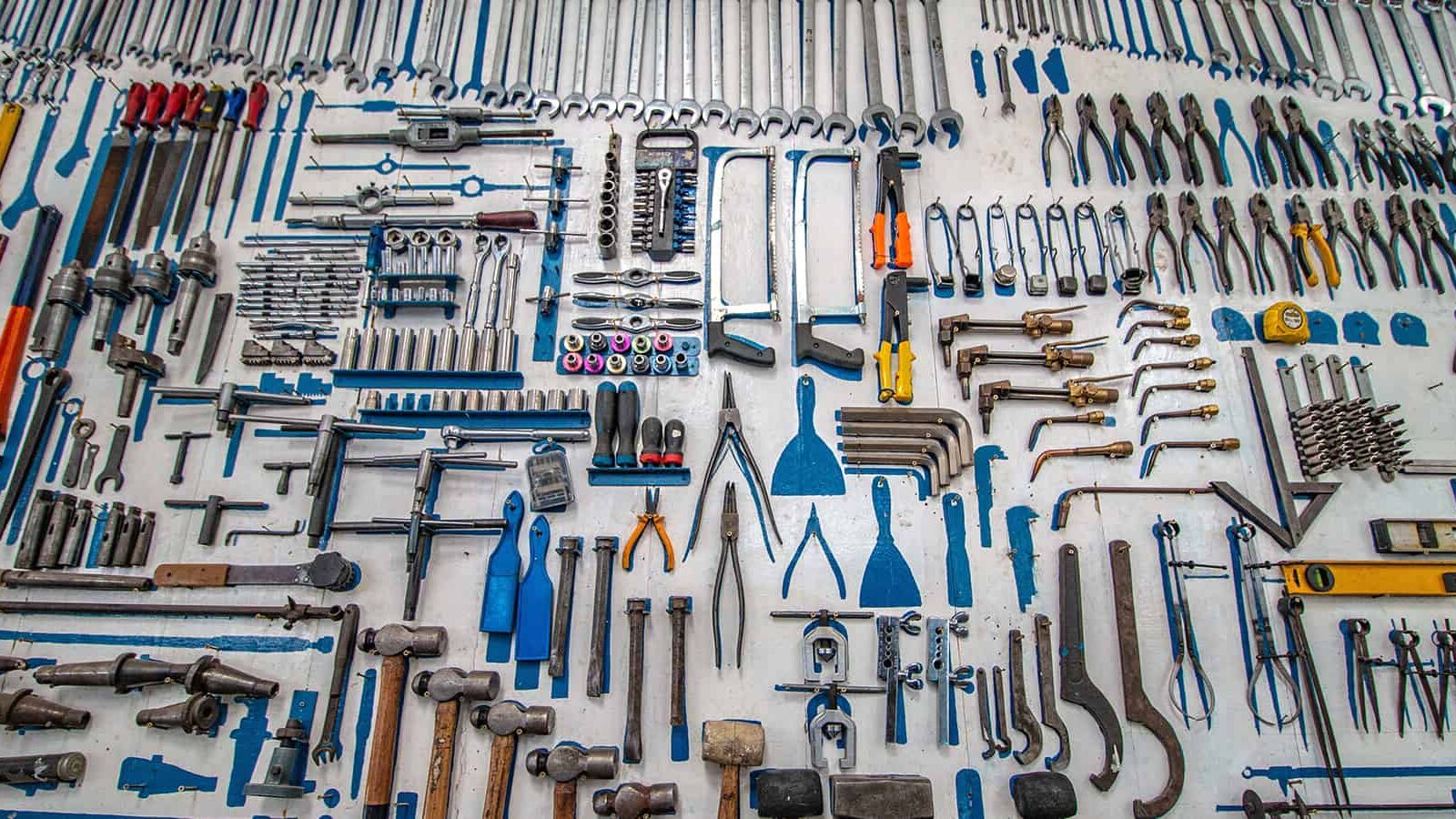 This is an image of all sorts of tools placed ona gray background and used in an article about how to create a content marketing strategy