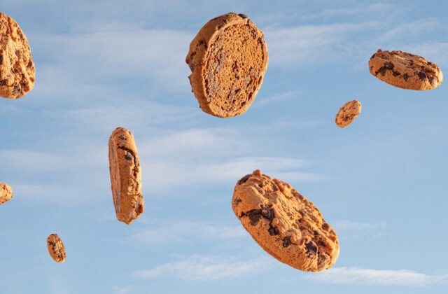 third-party cookies are on their way out. This image focuses on a blue cloudy sky with chocolate chip cookies appearing to rain down