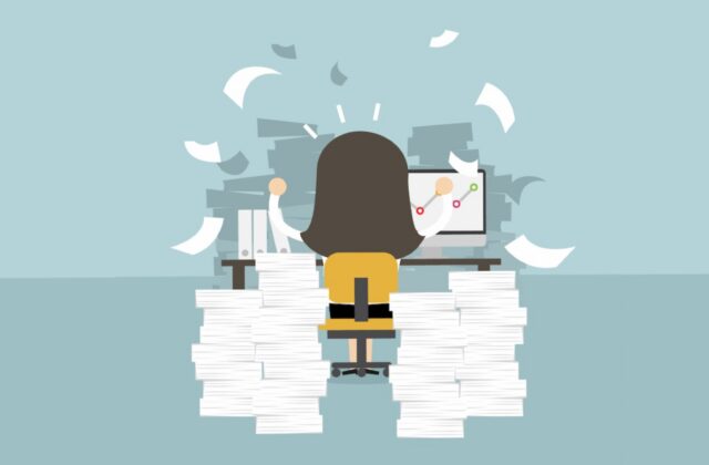 Graphic showing woman working with stack of papers signifying blog content for an article about refreshing blog content